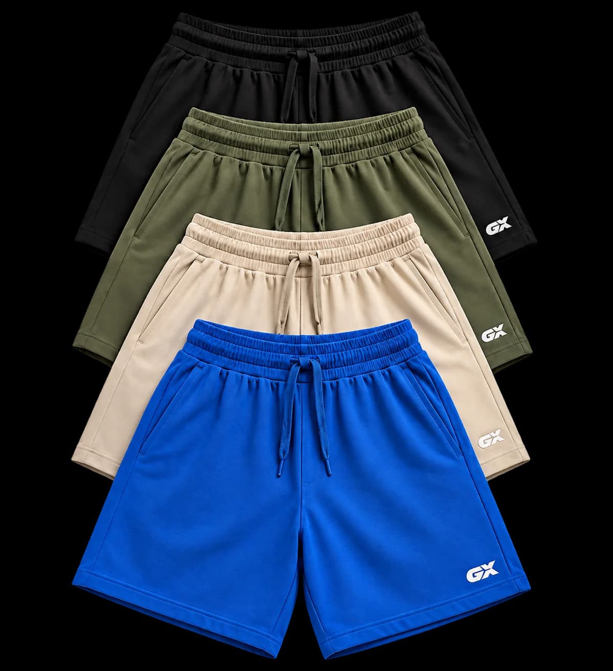 Four pairs of GX Flux Training Shorts stacked and fanned — black, olive, cream and blue.
