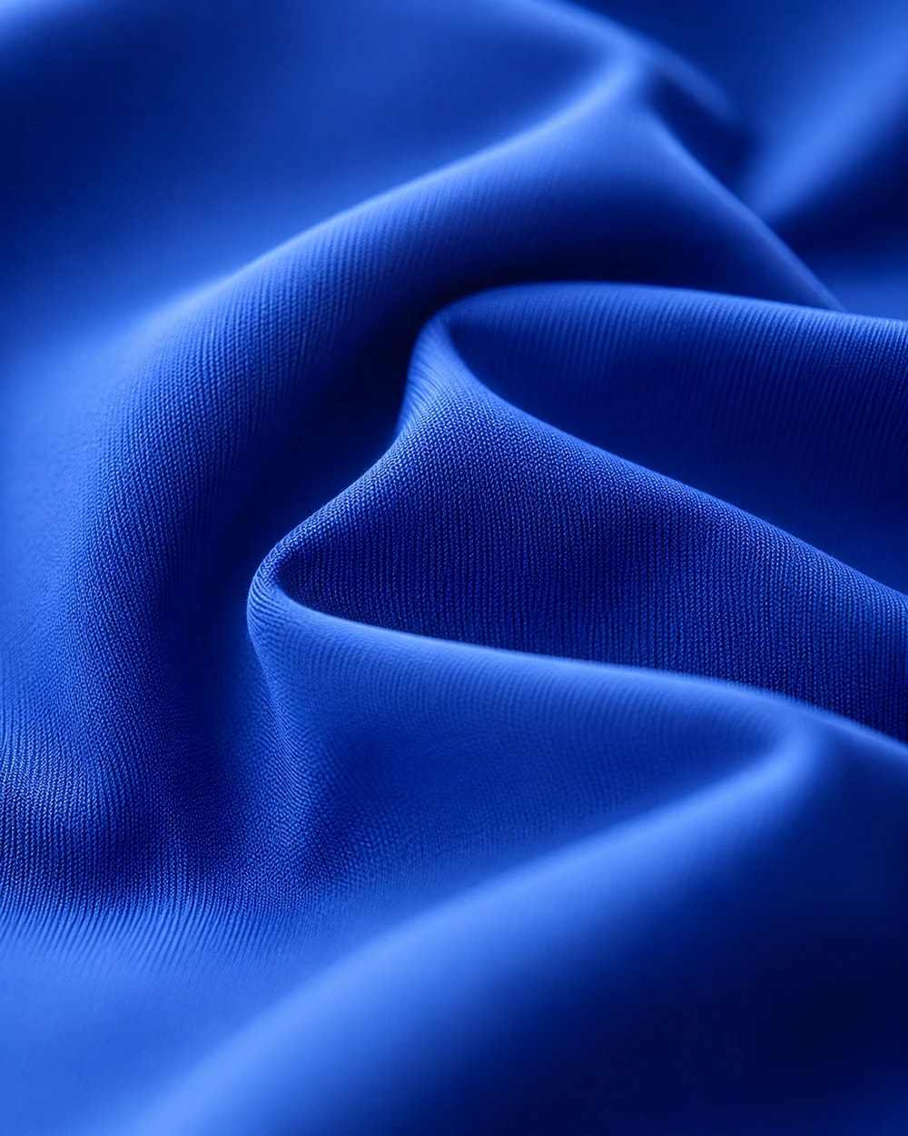 Macro close-up of the fine-gauge GX knit face and its drape